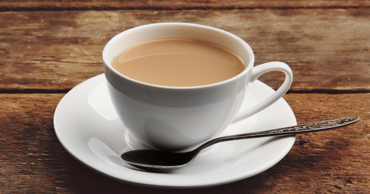 cup of tea with a saucer and plate on a table LED-Light-Therapy-My-Obsession-Your-Solution-and-Why-Cheap-Lights-Wont-Cut-It-proper-cup-of-tea-with-milk.